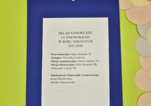 Plakat ogłaszający wyniki głosowania powieszony na zielonym tle.