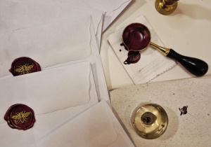 Zalakowane koperty zawierające pierwszą wskazówką na Mikołajkowe Podchody 2025.