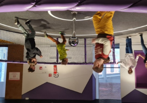 Dzieci biegają po makiecie układu słonecznego.